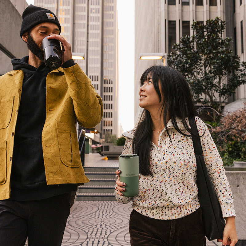 16oz-rise-tumbler-l0 16oz_rise_tumbler_black_iceberg_couple_drink_city_street_square.jpg