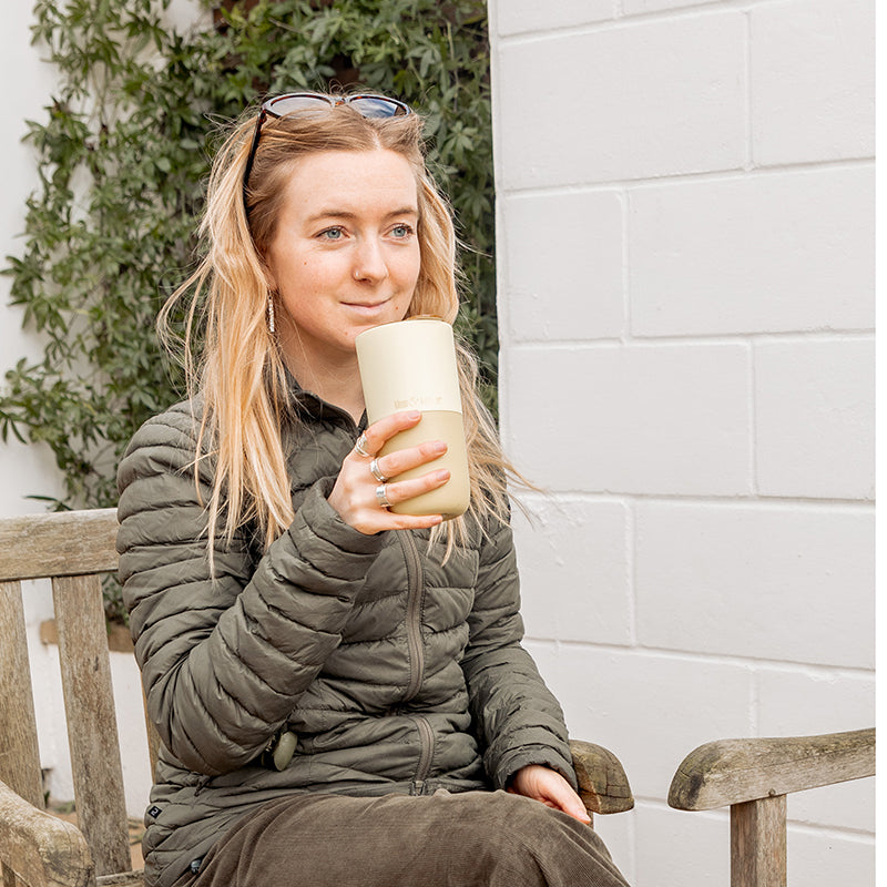16oz-rise-tumbler-l0 16oz_rise_tumbler_wax_yellow_woman_seat_outside_square.jpg