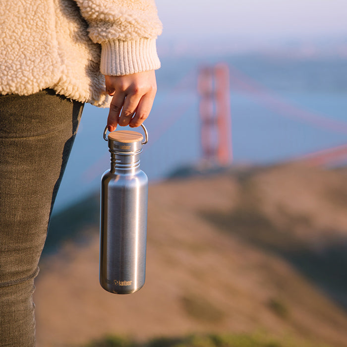 27oz-reflect-with-bamboo-cap-m3 K27SSLRF-BS-BAMBOO_reflect_bottle_bridge_lifestyle.jpg
